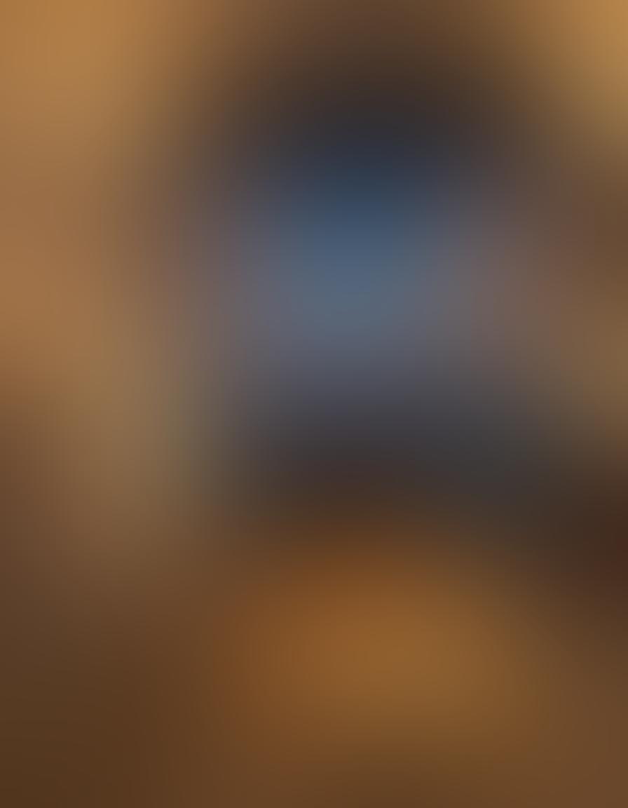 A cozy movie night scene with a couple snuggled under a blanket, surrounded by stacks of romantic movie DVDs and a glowing projector screen showing a heartwarming love story. Soft fairy lights twinkle in the background, creating an intimate atmosphere, with popcorn and drinks on a small table. The color palette should be warm and inviting, capturing the essence of romance and comfort. cozy, cinematic, vibrant colors.